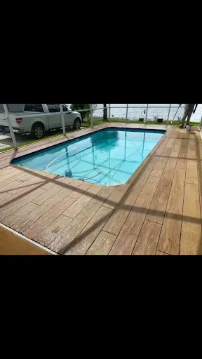 Pool deck in Wesley Chapel, FL with a wood-plank stamped concrete overlay around a rectangular pool